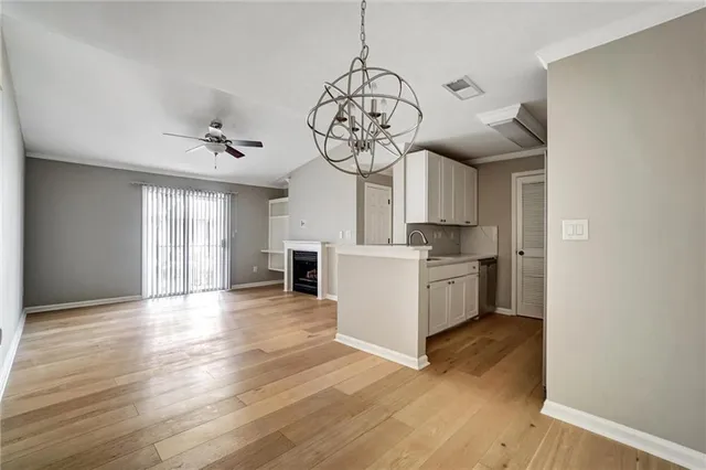 a view of a kitchen with a sink wooden floor and a window