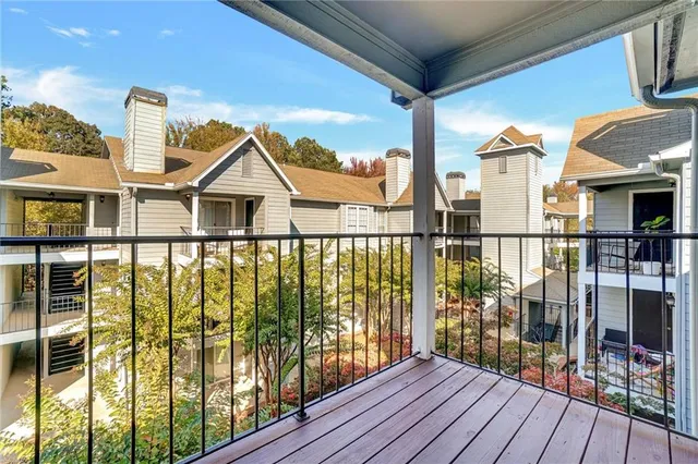 a view of a house with wooden floor next to a iron stairs