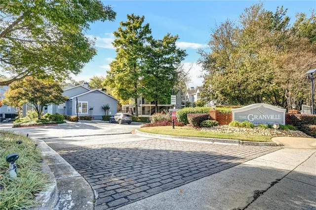 a view of a house with a yard and sitting area