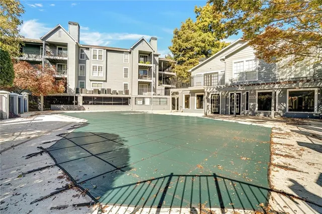 a view of a patio with couches table and chairs with wooden floor and fence