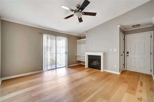 a view of a livingroom with a fireplace and window