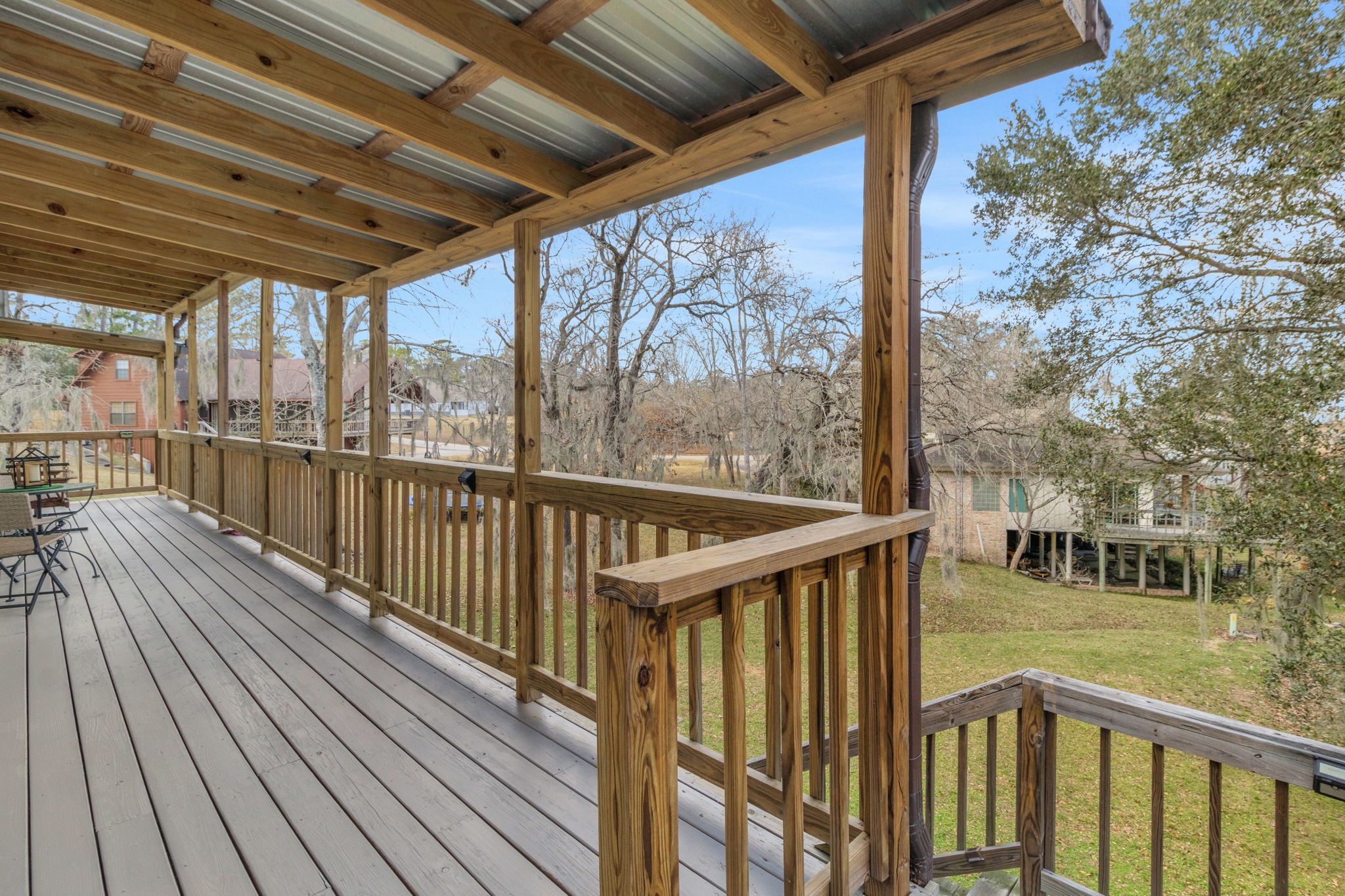 171 Kings Way Coldspring, TX 77331 - Photo 14 of 50 Steps from this deck lead to the expansive screened in porch and back yard