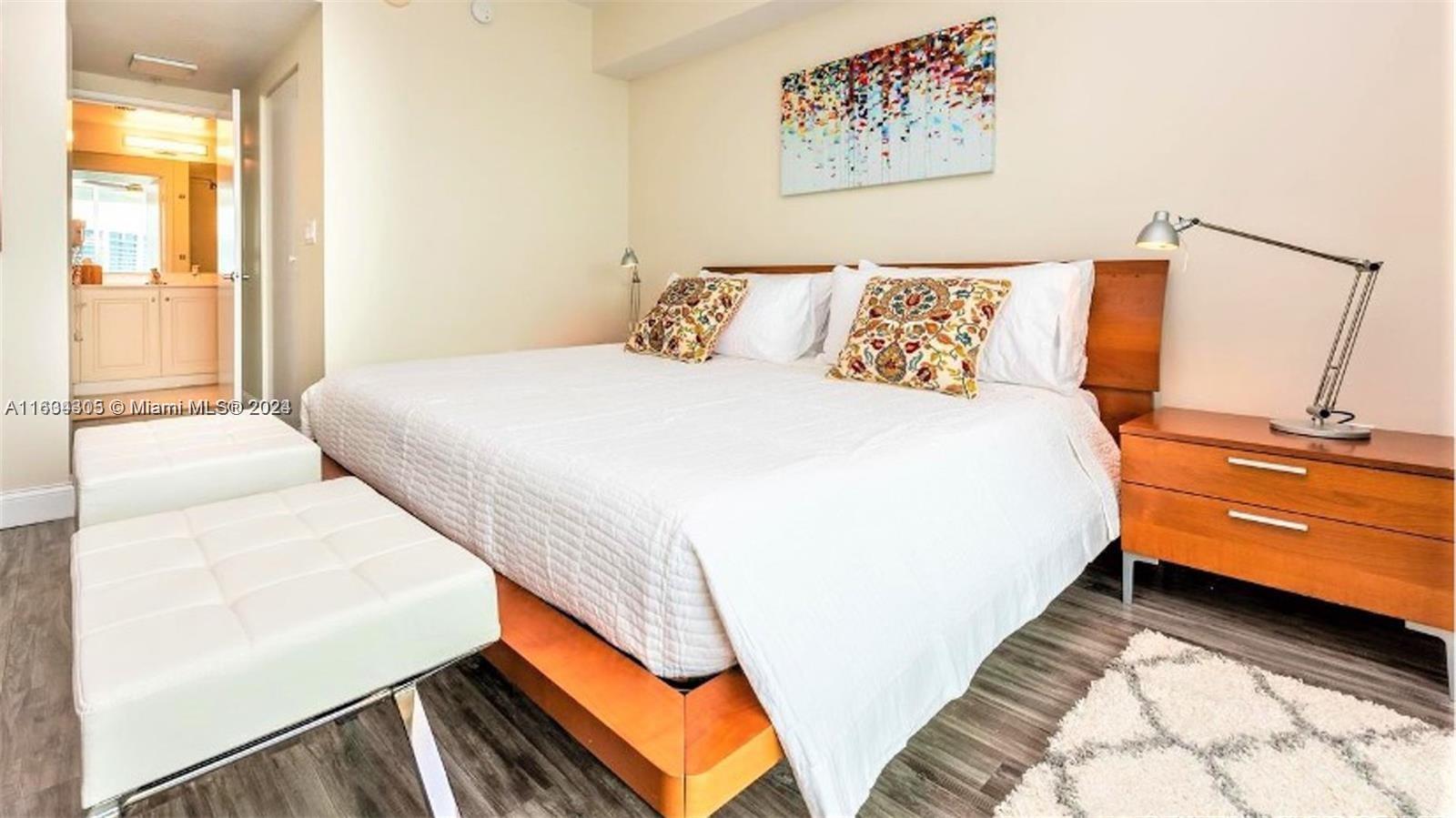 18100 North Bay Road, Unit 606 Sunny Isles Beach, FL 33160 - Photo 13 of 30 a bedroom with a bed and a painting on the wall