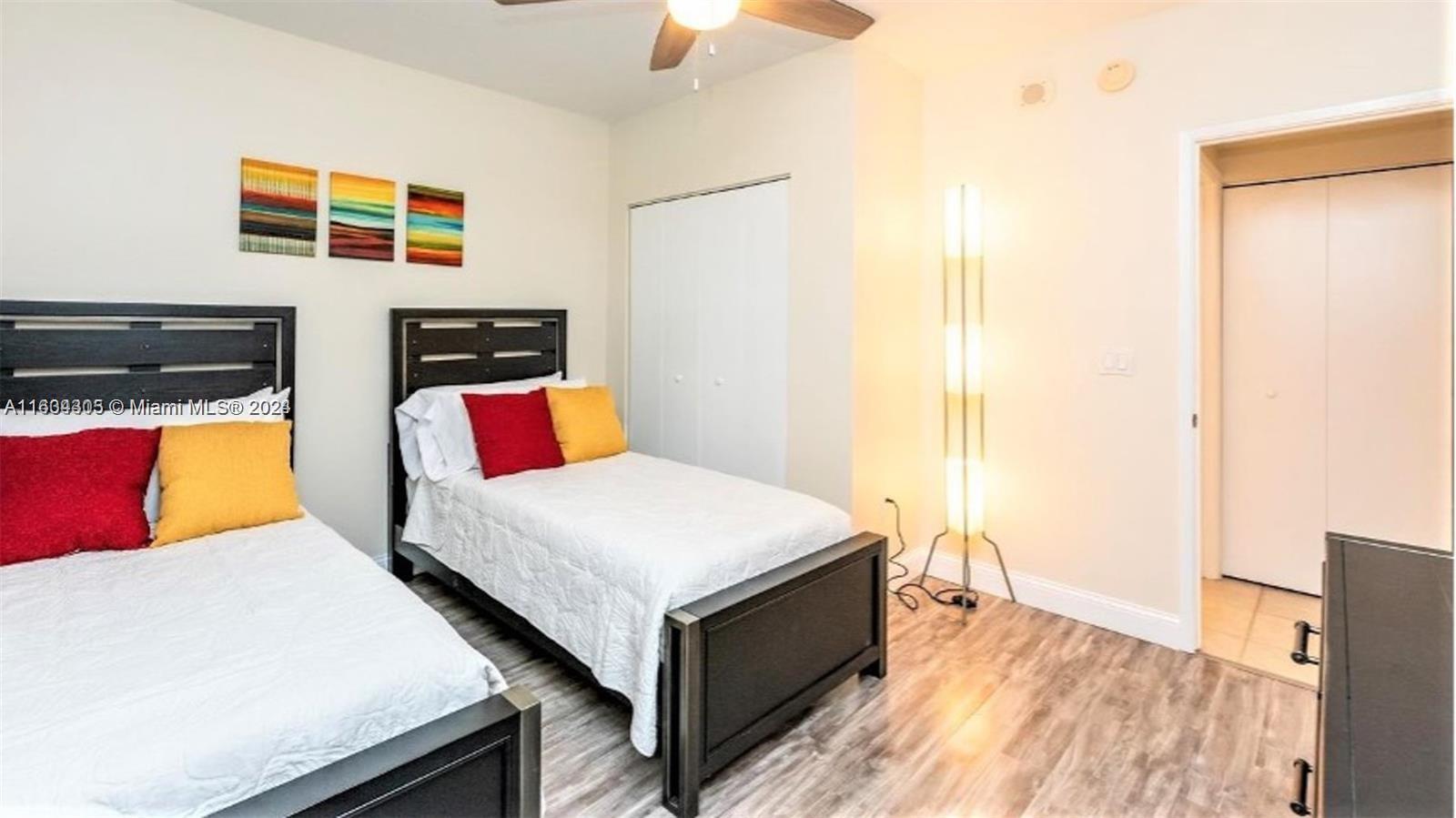 18100 North Bay Road, Unit 606 Sunny Isles Beach, FL 33160 - Photo 15 of 30 a bedroom with a bed and a couch