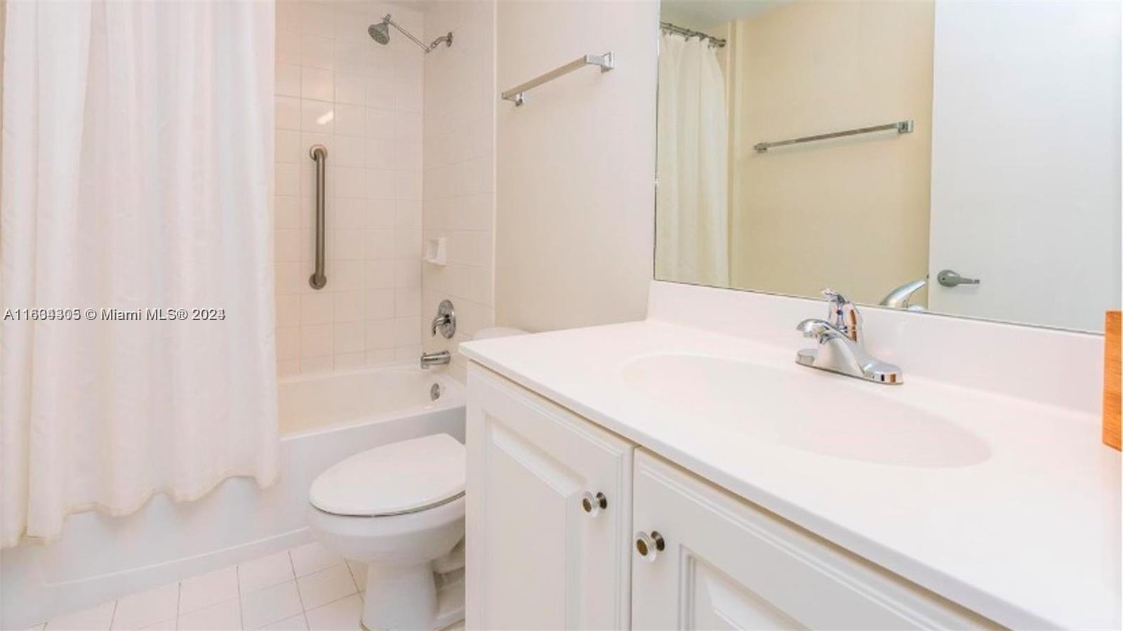 18100 North Bay Road, Unit 606 Sunny Isles Beach, FL 33160 - Photo 17 of 30 a bathroom with a sink a toilet and shower