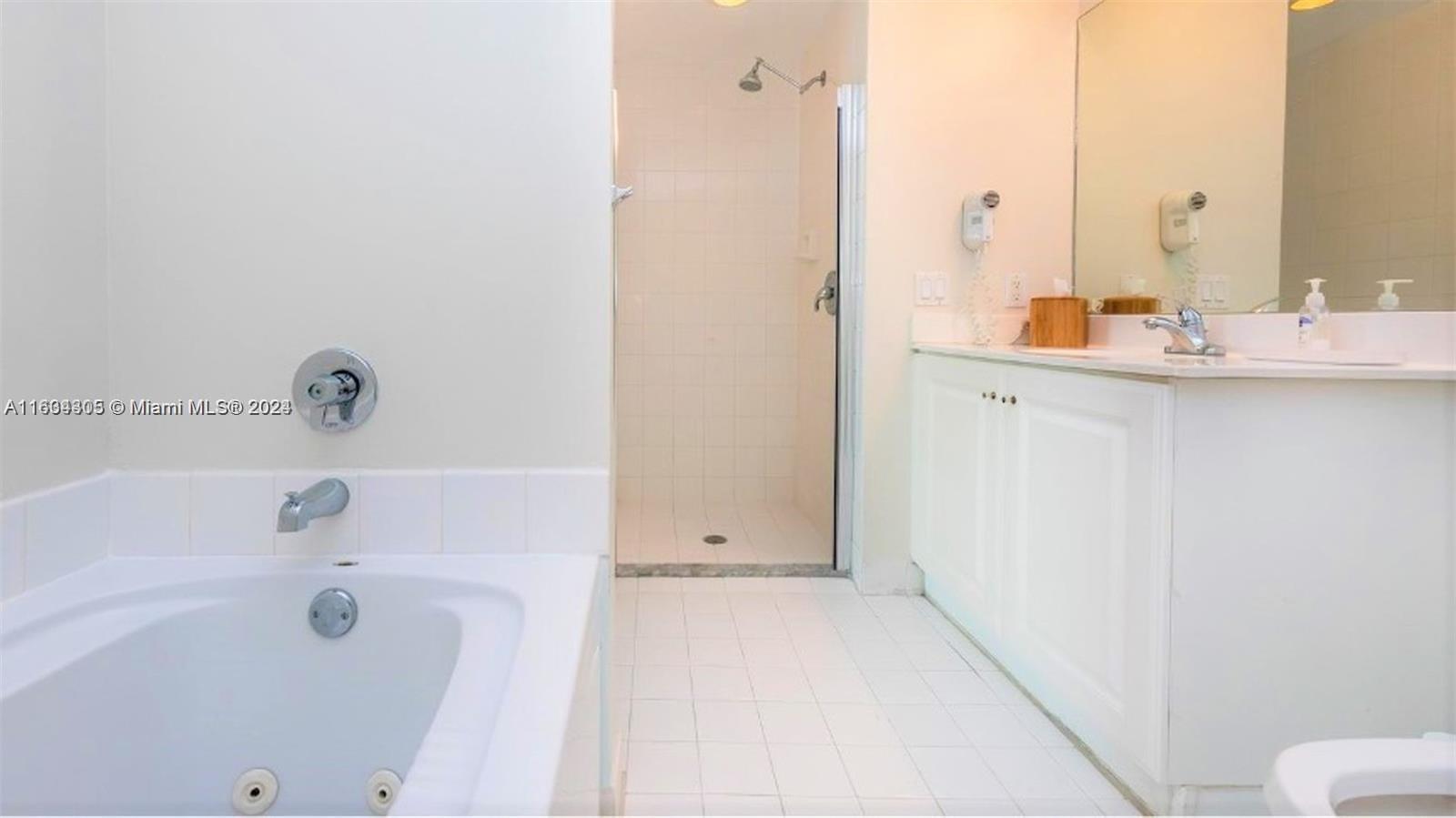 18100 North Bay Road, Unit 606 Sunny Isles Beach, FL 33160 - Photo 18 of 30 a bathroom with a bathtub and a sink