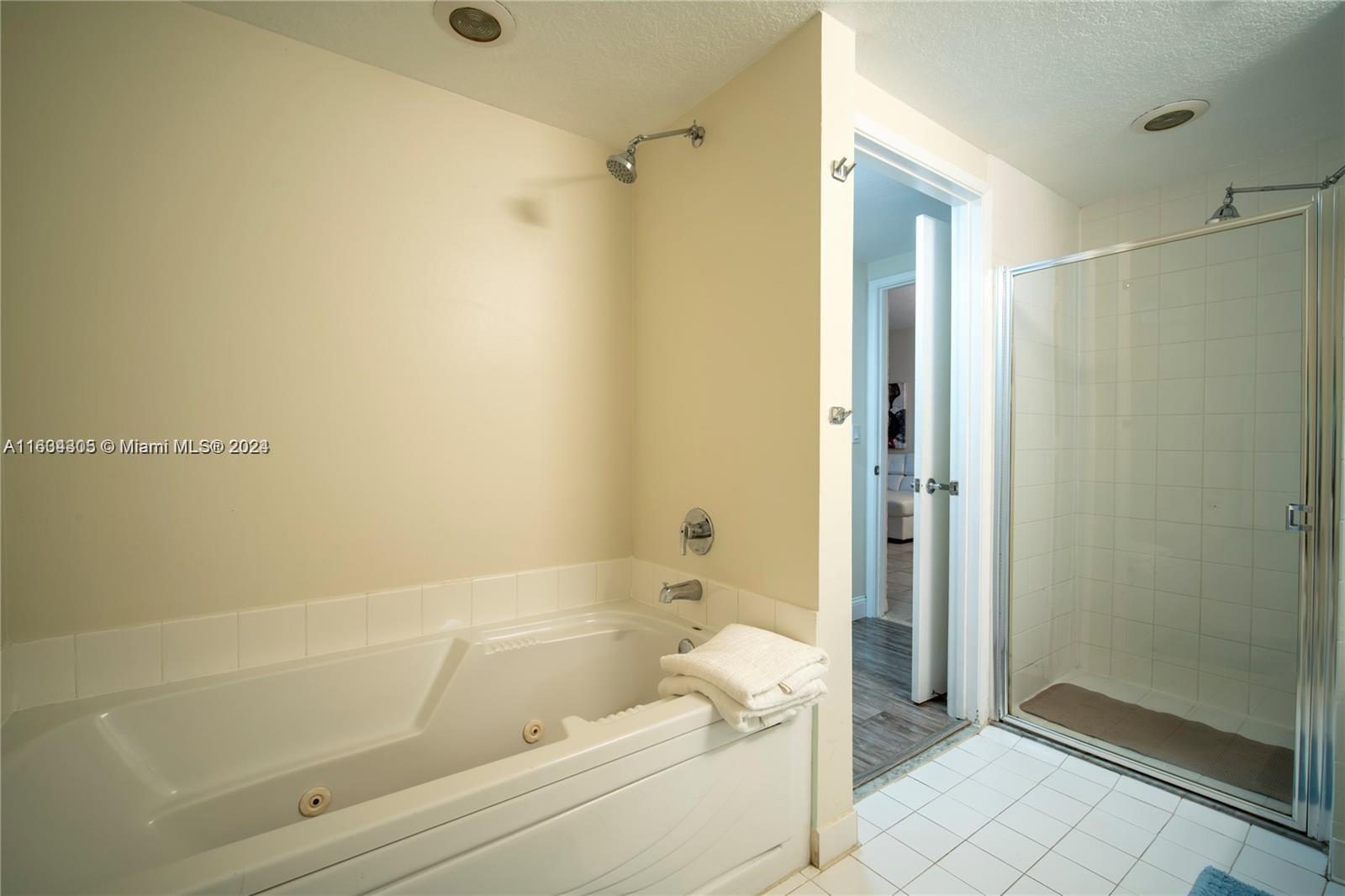 18100 North Bay Road, Unit 606 Sunny Isles Beach, FL 33160 - Photo 20 of 30 a bathroom with a bathtub and a shower