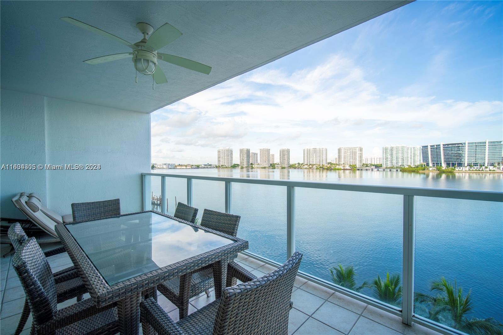 18100 North Bay Road, Unit 606 Sunny Isles Beach, FL 33160 - Photo 22 of 30 a view of a balcony with a table and chairs