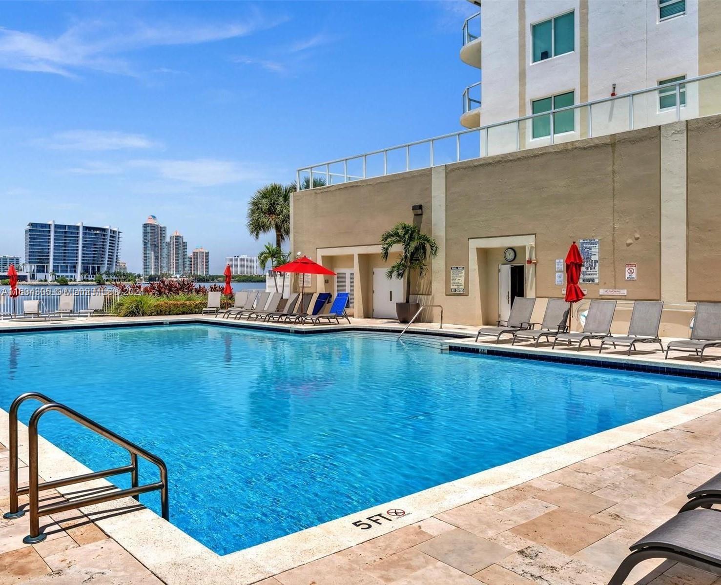 18100 North Bay Road, Unit 606 Sunny Isles Beach, FL 33160 - Photo 26 of 30 a view of swimming pool with outdoor seating