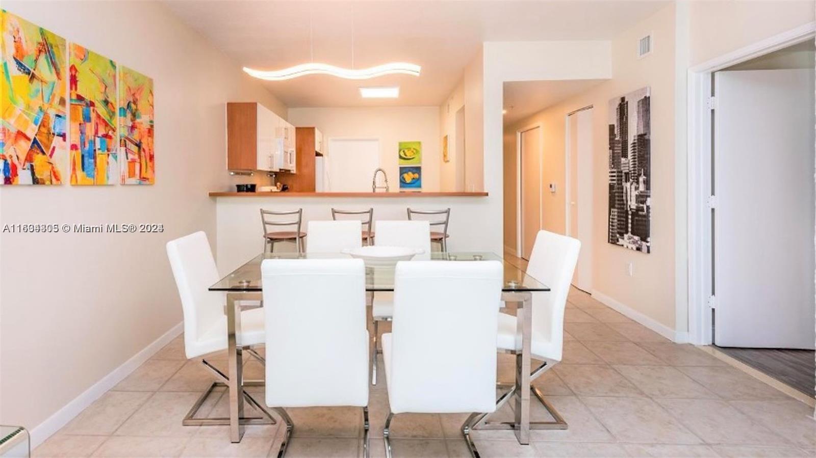 18100 North Bay Road, Unit 606 Sunny Isles Beach, FL 33160 - Photo 7 of 30 a view of a dining room with furniture and a window