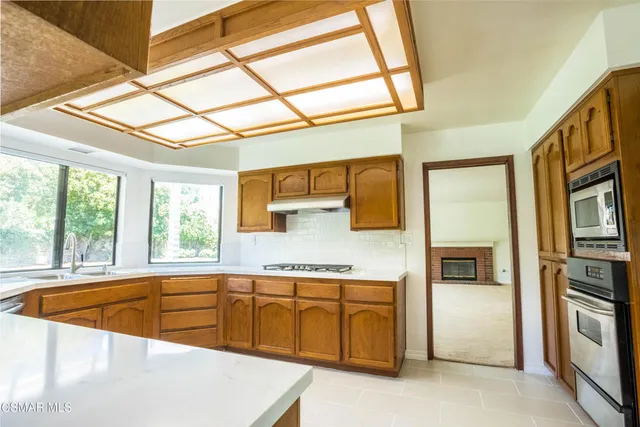 a kitchen with refrigerator and window