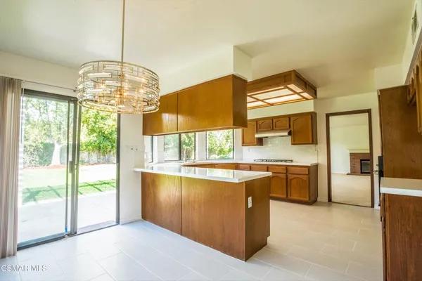 a dining room with floor to ceiling windows and a chandelier