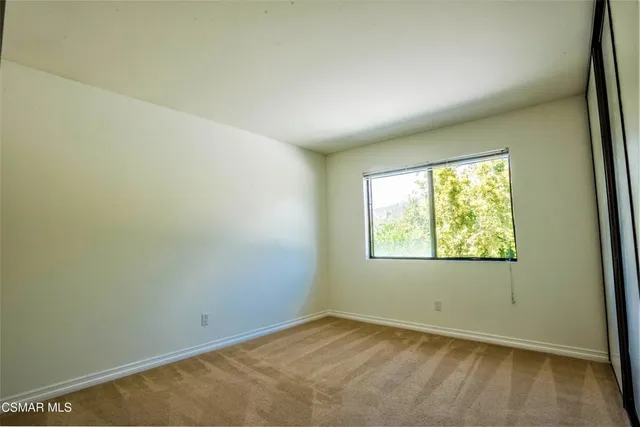 a view of an empty room with a fireplace