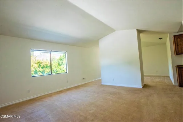 a view of an empty room with a fireplace