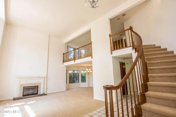 a view of a livingroom with furniture and staircase