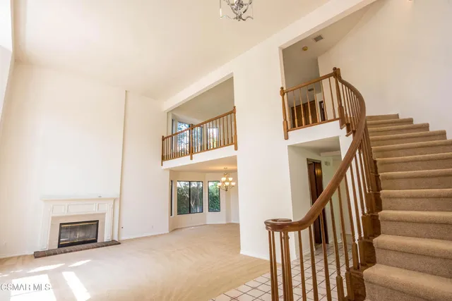 a view of a livingroom with furniture and staircase