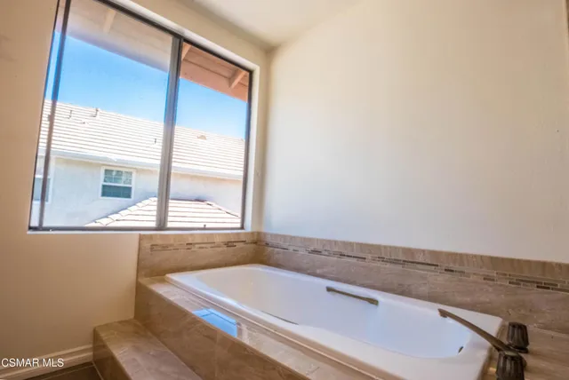 a bathroom with a tub and shower