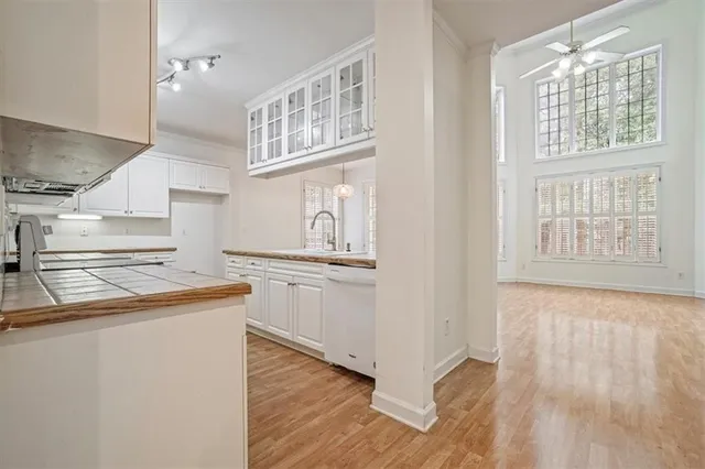 a kitchen with cabinets and wooden floor