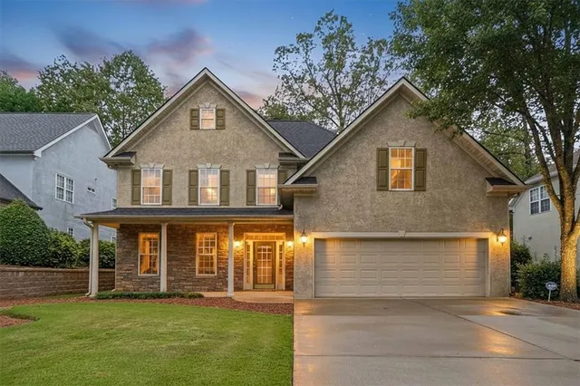 a front view of a house with a yard and garage