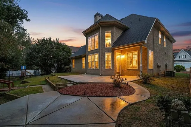 an aerial view of a house with swimming pool garden and patio