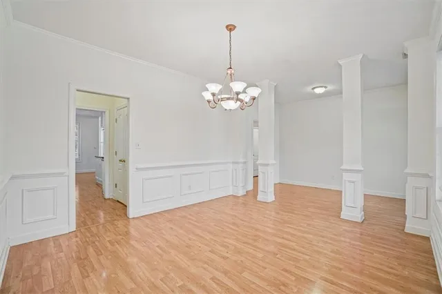 a view of a room with wooden floor