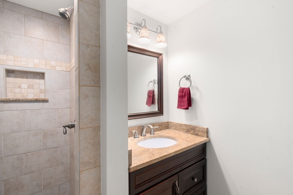 8 Jericho Road, Unit 8 Weston, MA 02493 - Photo 16 of 19 a bathroom with a granite countertop sink and a mirror