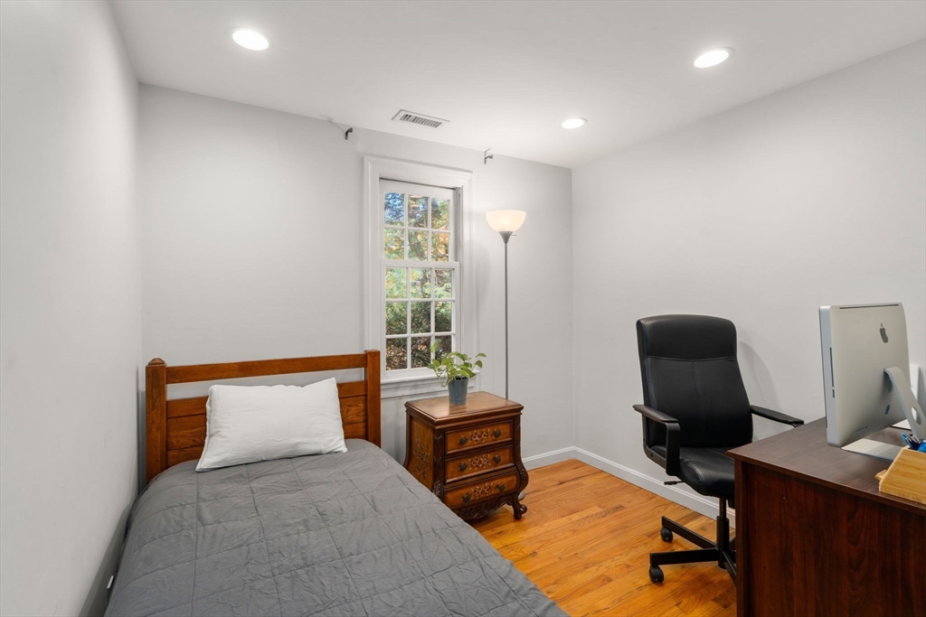 8 Jericho Road, Unit 8 Weston, MA 02493 - Photo 17 of 19 a bedroom with a bed a desk and chair