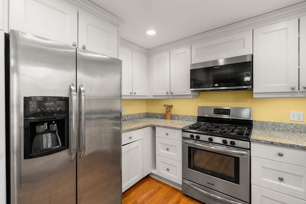 8 Jericho Road, Unit 8 Weston, MA 02493 - Photo 10 of 19 a kitchen with stainless steel appliances granite countertop a stove a refrigerator and a microwave