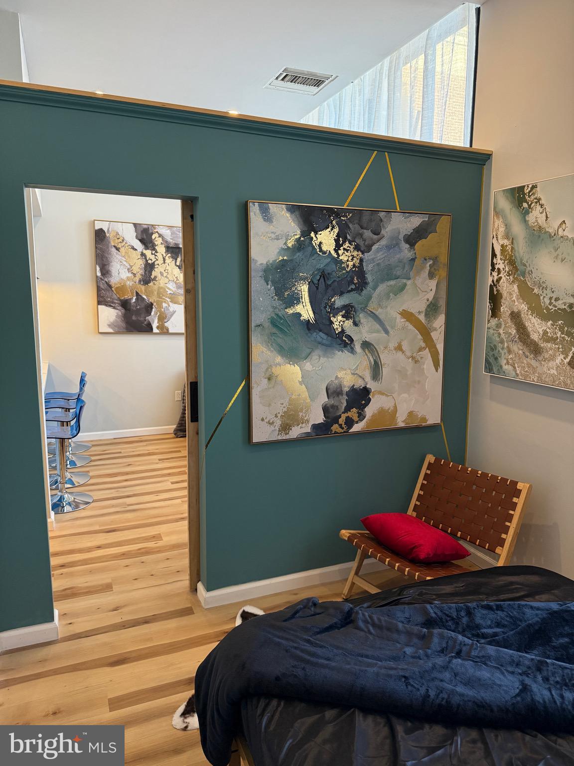 1601 Spring Garden Street, Unit 318 Philadelphia, PA 19130 - Photo 12 of 31 a bedroom with a bed and painting on the wall