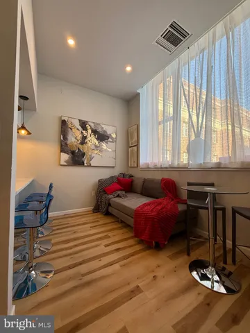 a bathroom with a sink and mirror with bathtub