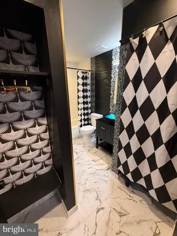 a bathroom with a sink mirror vanity and toilet