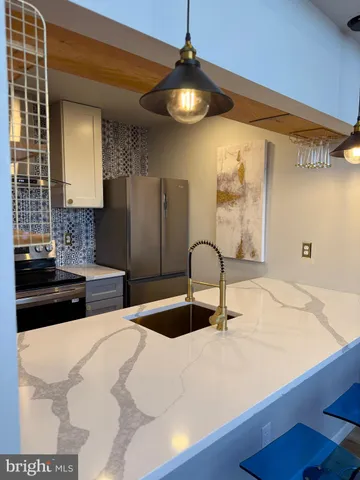 a kitchen with a sink and a refrigerator