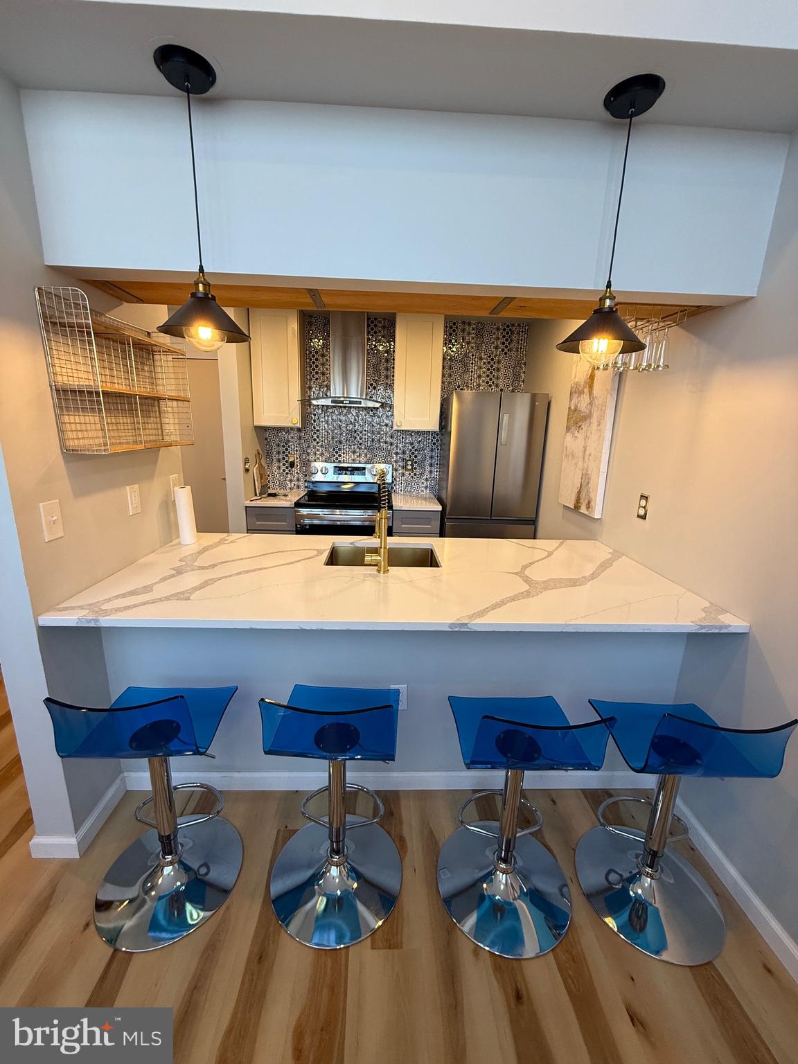 1601 Spring Garden Street, Unit 318 Philadelphia, PA 19130 - Photo 6 of 31 a room with a table chairs and a wooden floor