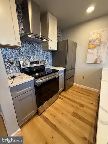 a kitchen with a stove and a refrigerator