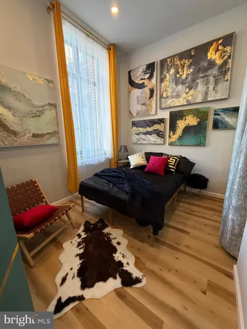 a bed sitting in a bedroom next to a window