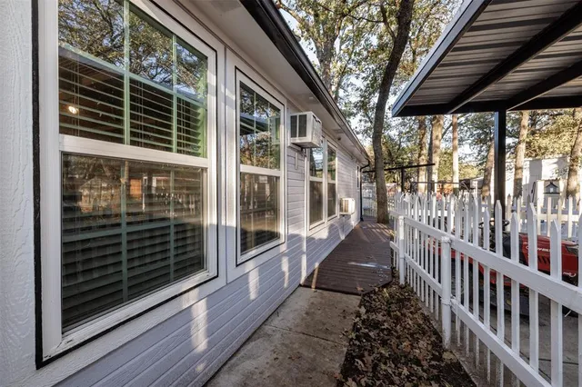 a view of a porch with wooden floor and iron stairs