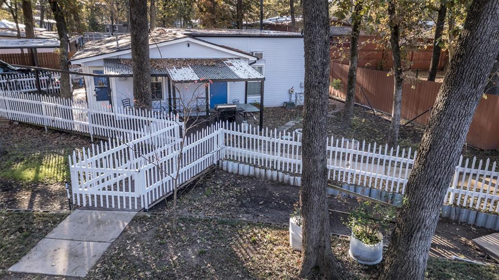 9953 Green Tree Lane Wills Point, TX 75169 - Photo 5 of 39 a view of a house with a small yard and wooden deck