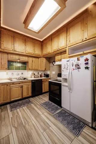 a kitchen with stainless steel appliances a sink and cabinets
