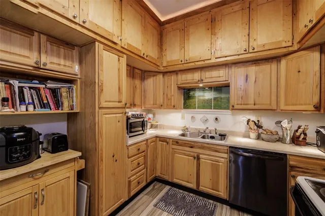 a kitchen with stainless steel appliances granite countertop a sink and cabinets