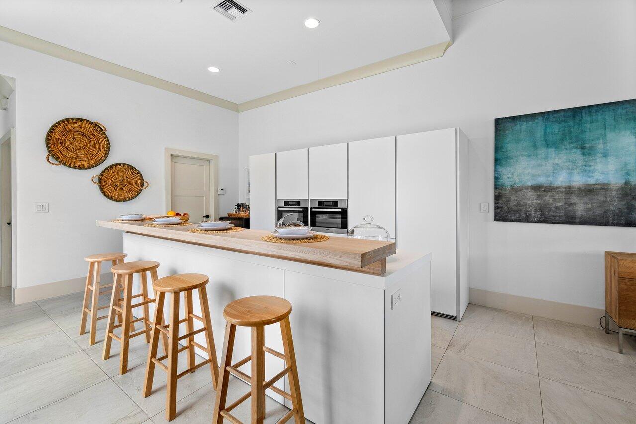 5848 Northwest 39th Avenue Boca Raton, FL 33496 - Photo 12 of 37 a kitchen with a table and chairs in it