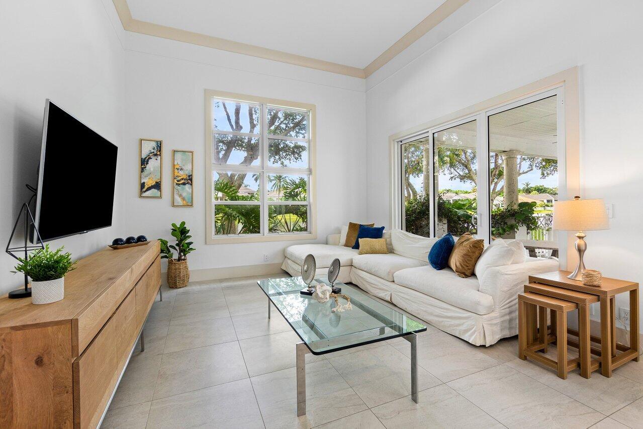 5848 Northwest 39th Avenue Boca Raton, FL 33496 - Photo 14 of 37 a living room with furniture a flat screen tv and a large window