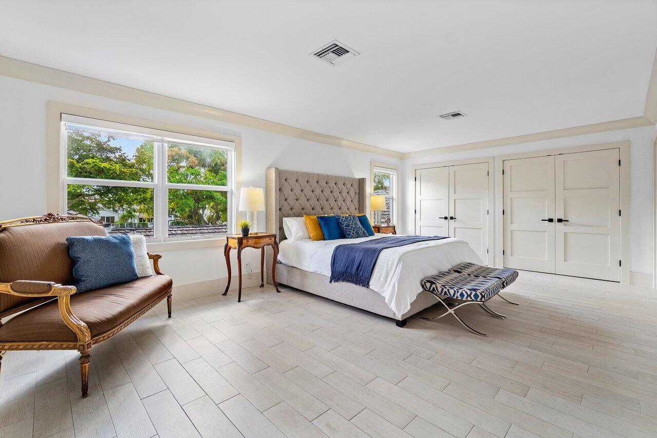 5848 Northwest 39th Avenue Boca Raton, FL 33496 - Photo 17 of 37 a bedroom with a bed and a couch next to a window