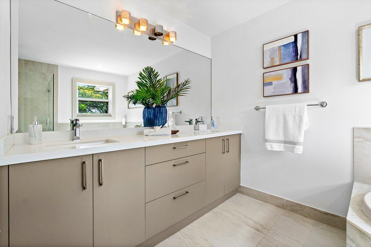 5848 Northwest 39th Avenue Boca Raton, FL 33496 - Photo 20 of 37 a bathroom with a double vanity sink and a mirror
