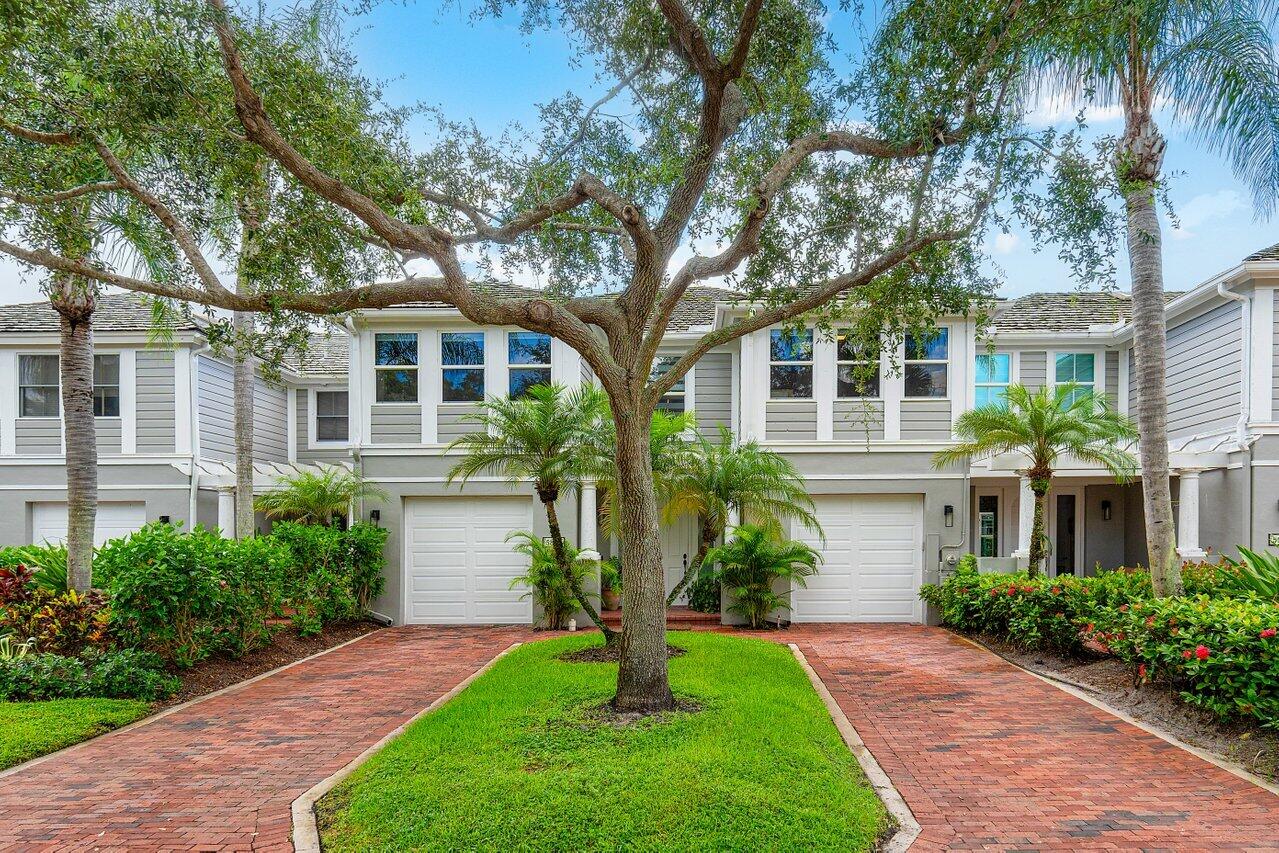 5848 Northwest 39th Avenue Boca Raton, FL 33496 - Photo 2 of 37 a front view of a house with a yard and palm trees