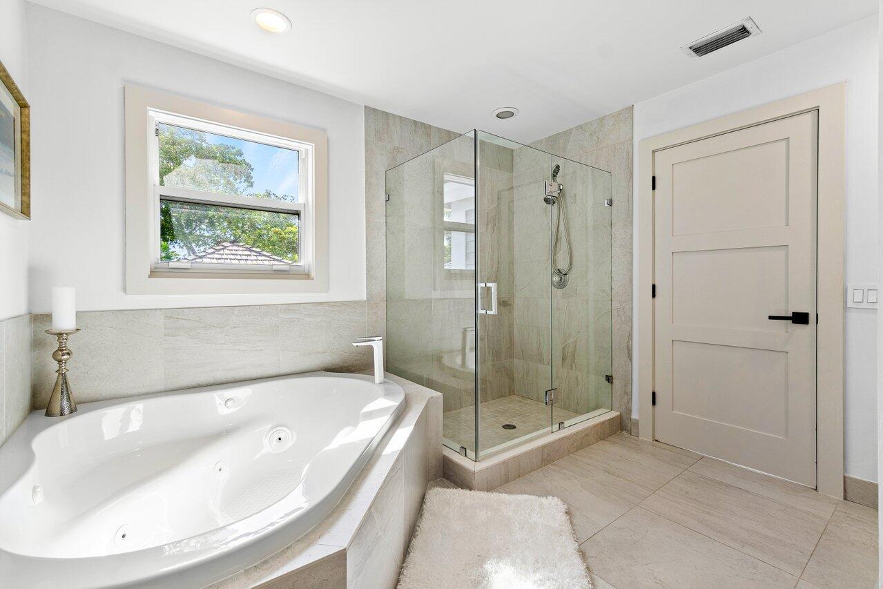 5848 Northwest 39th Avenue Boca Raton, FL 33496 - Photo 22 of 37 a bathroom with a tub shower and window
