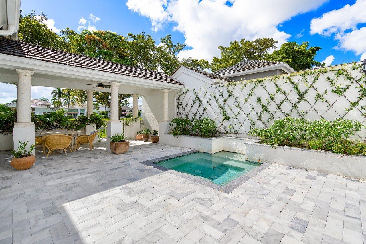 5848 Northwest 39th Avenue Boca Raton, FL 33496 - Photo 26 of 37 a view of a chair and table in backyard of the house