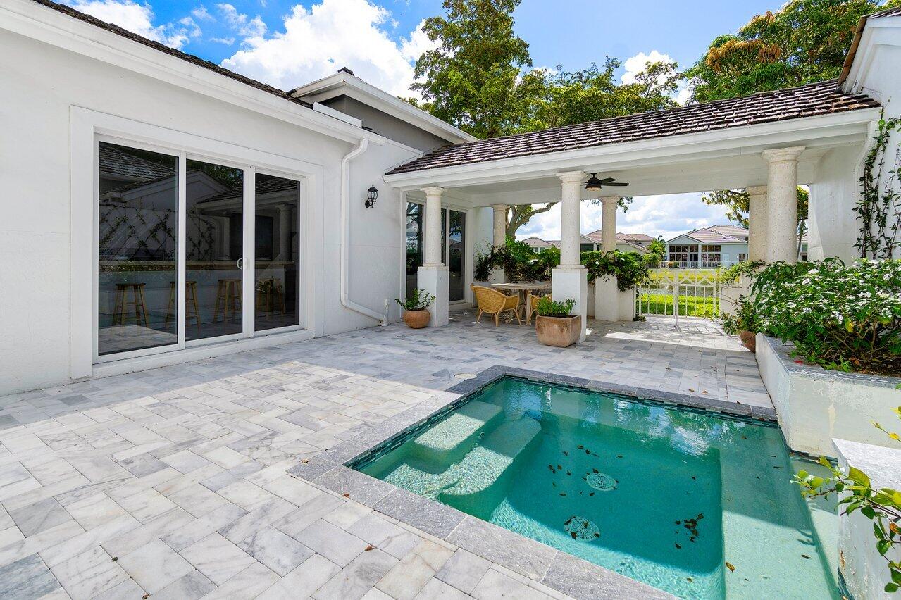 5848 Northwest 39th Avenue Boca Raton, FL 33496 - Photo 28 of 37 a view of a house with sitting area and garden