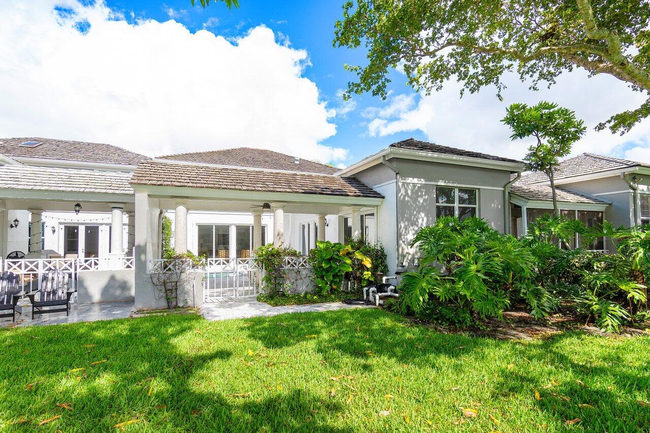 5848 Northwest 39th Avenue Boca Raton, FL 33496 - Photo 30 of 37 a front view of house with yard and outdoor seating