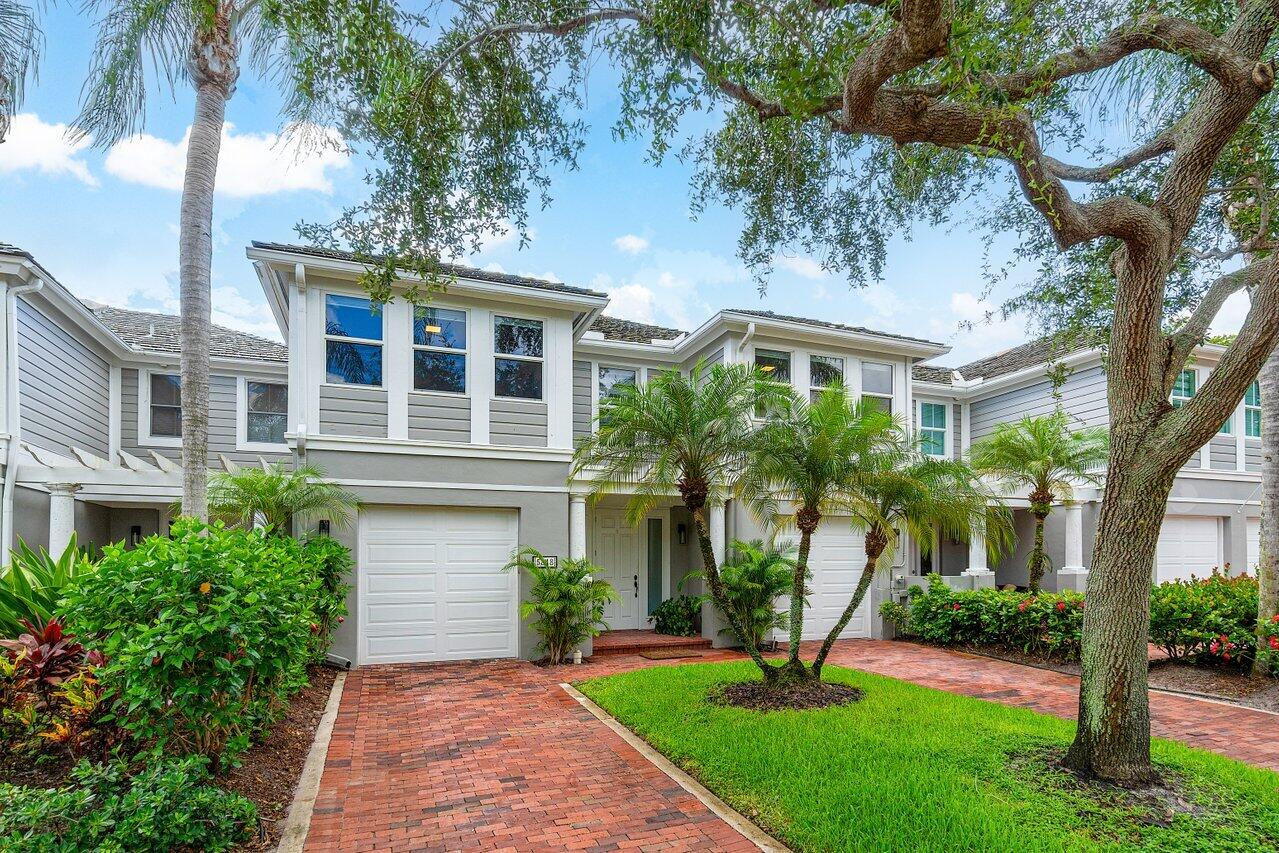 5848 Northwest 39th Avenue Boca Raton, FL 33496 - Photo 3 of 37 a front view of a house with a yard and large tree