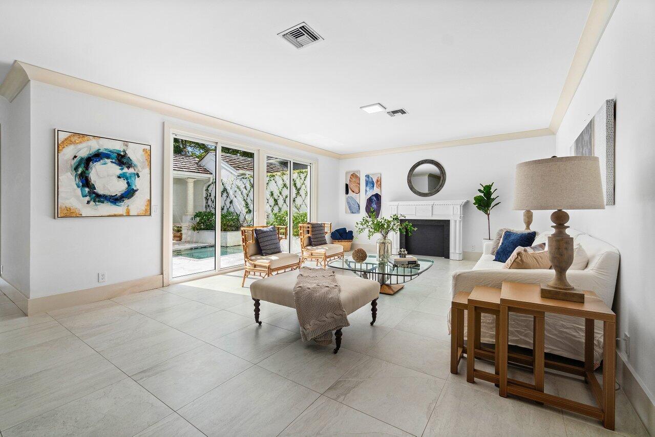 5848 Northwest 39th Avenue Boca Raton, FL 33496 - Photo 5 of 37 a living room with fireplace furniture and a large window